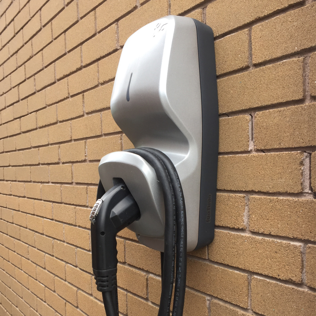 Wall mounted EV charger installed on brick wall